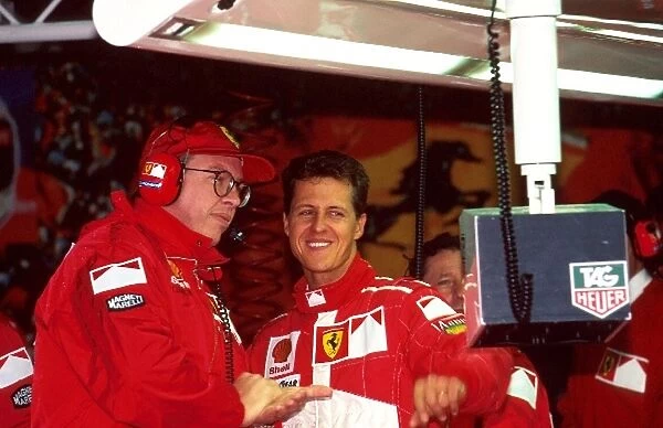 Formula One World Championship: Michael Schumacher, Ferrari F310B with Ross Brawn, left