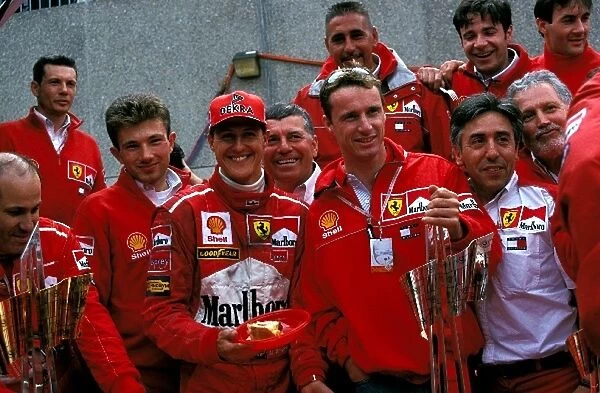 Formula One World Championship: Michael Schumacher & team mate Eddie Irvine. Ferrari team prinicpal Franco Gozzi can be seen second from right