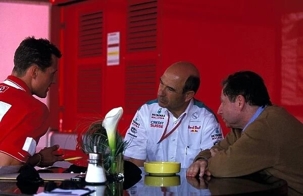 Formula One World Championship: Michael Schumacher Ferrari, left, talks with Peter Sauber Sauber boss and Jean Todt Ferrari sporting director