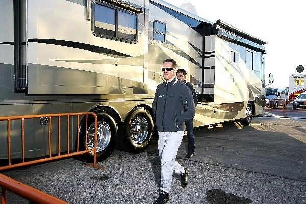 Formula One World Championship: Michael Schumacher Mercedes GP leaves the motorhome of brother Ralf Schumacher in the paddock