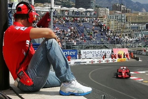 Formula One World Championship: Michael Schumacher Ferrari watches Kimi Raikkonen Ferrari F2008