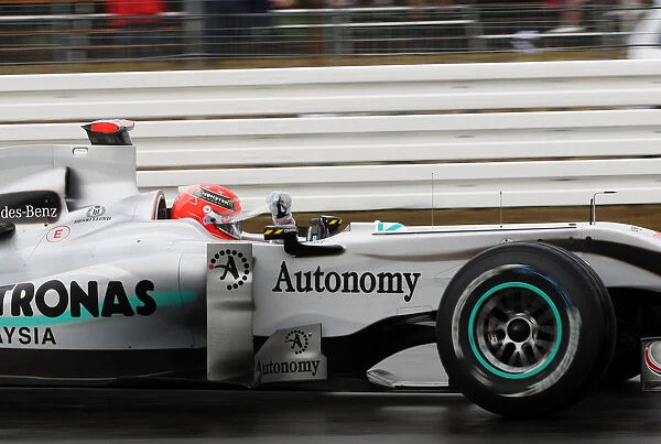 Formula One World Championship: Michael Schumacher Mercedes GP MGP W01 removes a tear off visor from his helmet
