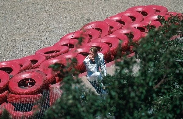 Formula One World Championship: Mika Hakkinen McLaren sits by the tyre barriers after leaving the circuit during practice