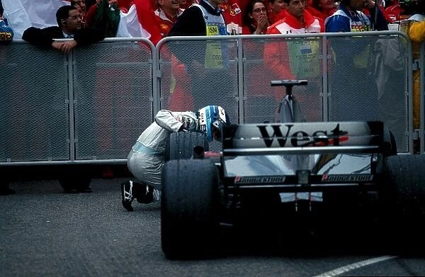 Formula One World Championship: Mika Hakkinen Mclaren MP4-15, 2nd place, looks for damage to his car after the race