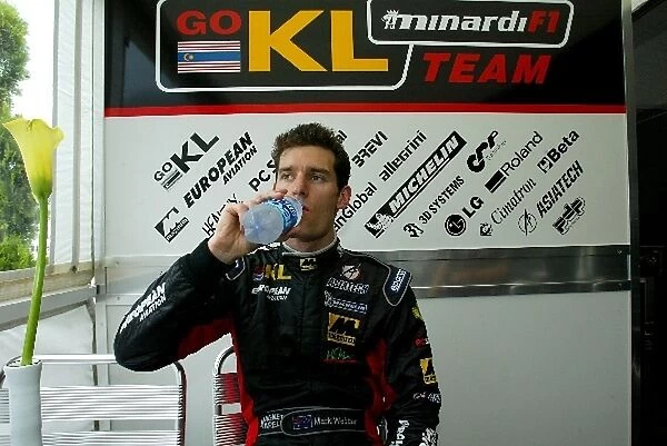 Formula One World Championship: Minardi driver Mark Webber has a refreshing drink