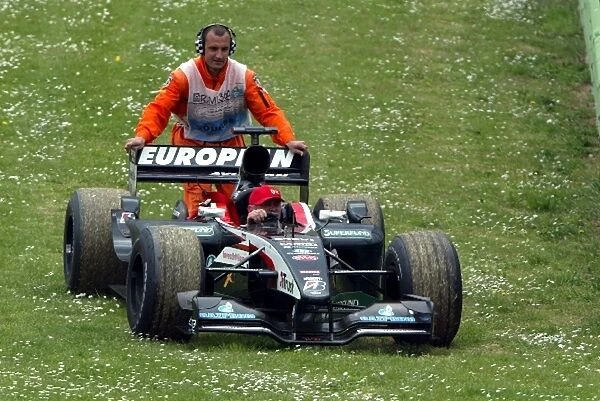 Formula One World Championship: The Minardi PS03 of Jos Verstappen is pushed away after his retirement
