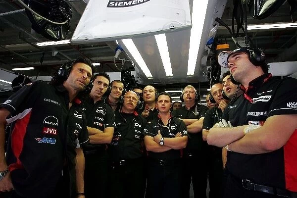 Formula One World Championship: The Minardi team watch qualifying