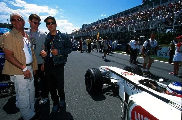 Formula One World Championship: Movie Star Jim Carrey stands on the grid alongside the BAR of Olivier Panis