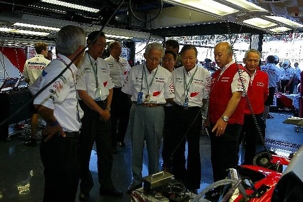Formula One World Championship: Mr Nakamura President of Panasonic is given a Toyota garage tour by Toshiro Kurusu Executive Vice-President Toyota