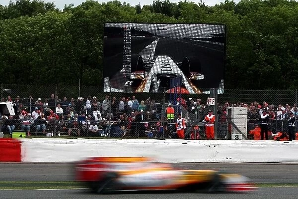 Formula One World Championship: Nelson Piquet Jr. Renault R29 passes himself on the big screen