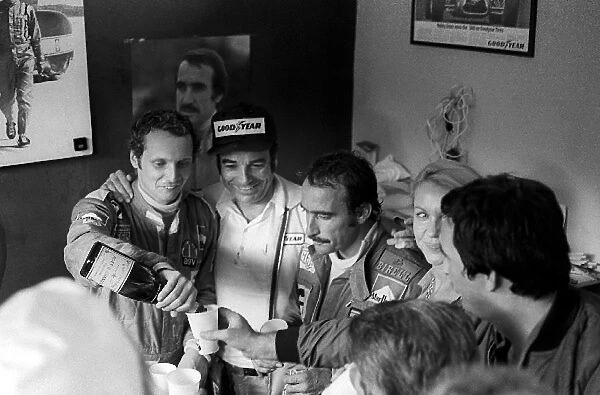 Formula One World Championship: New World Champion Niki Lauda celebrates with race winner and Ferrari team mate Clay Regazzoni in the Ferrari