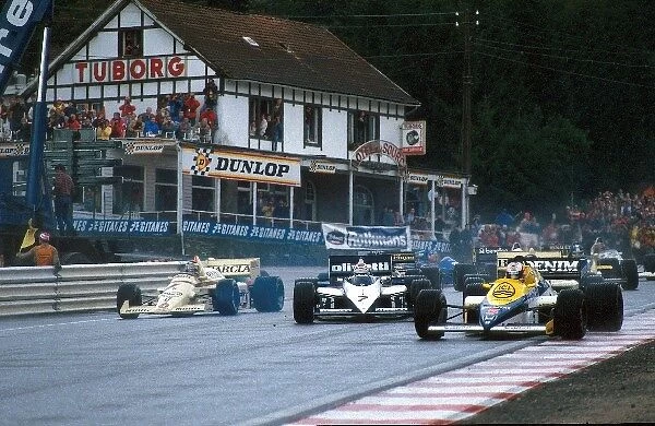 Formula One World Championship: Nigel Mansell Williams FW10, leads the field around La Source hairpin