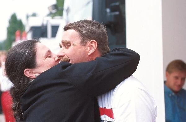 Formula One World Championship: Nigel Mansell is embraced by an over enthusisatic fan on his return to GP racing