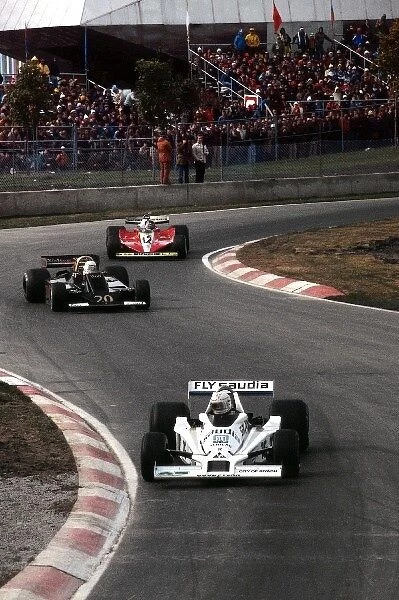 Formula One World Championship: Ninth placed Alan Jones FW06 was the last finisher on the lead lap, shown just ahead of second placed Jody Scheckter Wolf WR5