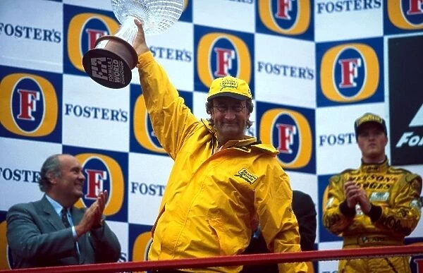 Formula One World Championship: An overjoyed Eddie Jordan is hoisted aloft by his first Jordan race winner Damon Hill and second place finisher