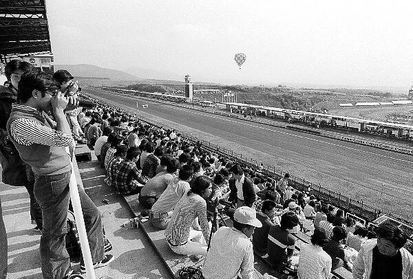Formula One World Championship: A packed grandstand during practice on the long main straight overlooking the pits