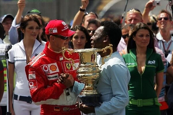 Formula One World Championship: Pele presents Michael Schumacher Ferrari with a trophy to mark the end of his career