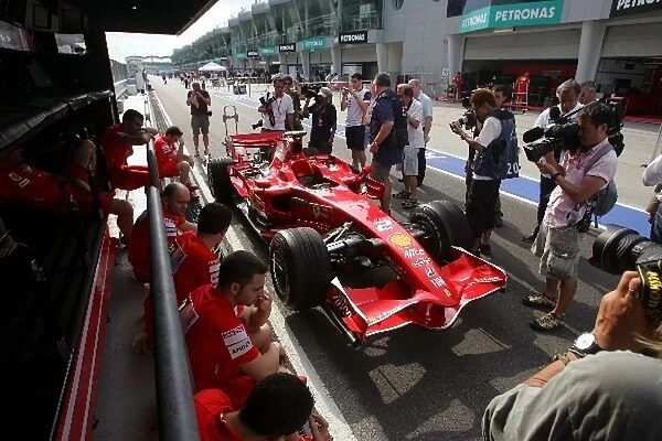 Formula One World Championship: Photographers crowd around the car of Felipe Massa Ferrari F2008 in the pitlane