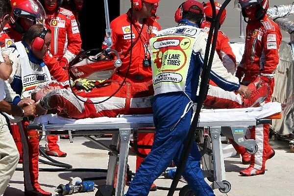 Formula One World Championship: Pietro Timpini Ferrari mechanic is injured during the pit stop of Kimi Raikkonen Ferrari