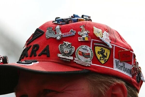 Formula One World Championship: Pin badges on a Ferrari cap