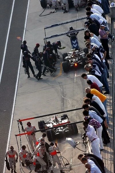 Formula One World Championship: Pitstop during qualifying for Mark Webber Red Bull Racing RB4 and Lewis Hamilton McLaren Mercedes MP4  /  23
