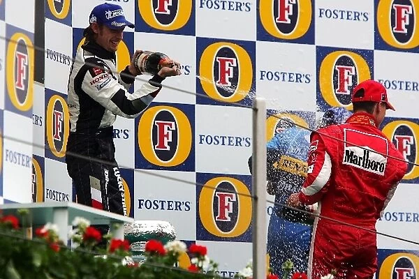 Formula One World Championship: Third place Jenson Button sprays second place finished Michael Schumacher Ferrari with champagne on the podium