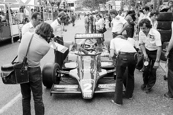 Formula One World Championship: Third placed Carlos Reutemann Lotus 79 in the pits with mechanics and a photographer