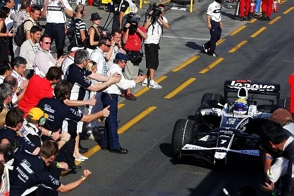 Formula One World Championship: Third placed Nico Rosberg Williams FW30 is cheered by Jackie Stewart and his team as he heads to parc ferme