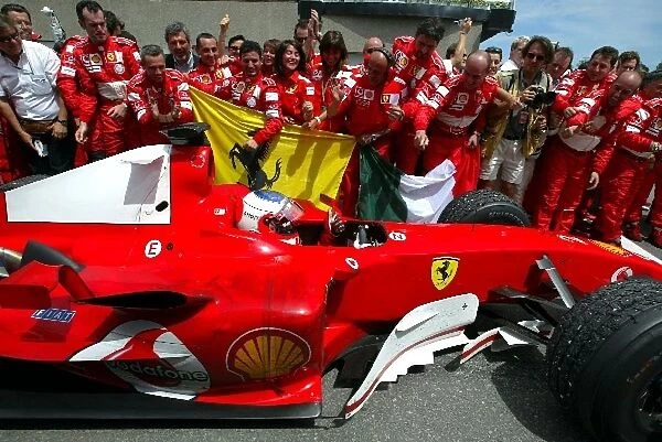 Formula One World Championship: Third placed Rubens Barrichello Ferrari F2004 arrives in Parc Ferme
