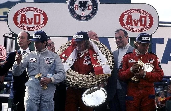 Formula One World Championship: The podium: Jody Scheckter Tyrrell, second; James Hunt McLaren, winner; Jochen Mass, McLaren, third
