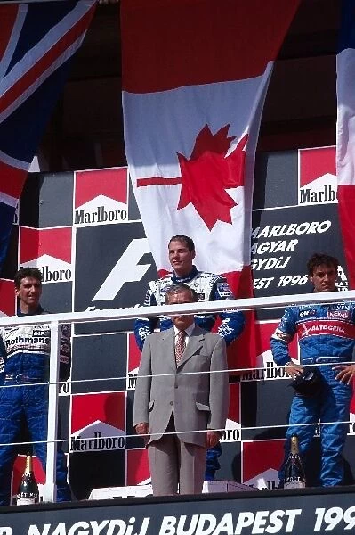 Formula One World Championship: On the podium: Damon Hill Williams second, Jacques Villeneuve Williams first and Jean Alesi Benetton third