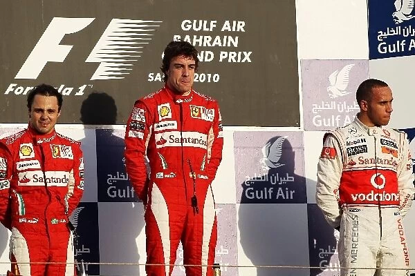 Formula One World Championship: The podium: Second placed Felipe Massa Ferrari with race winner Fernando Alonso Ferrari and third placed Lewis