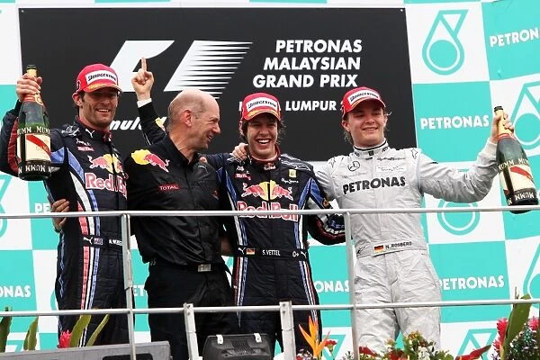 Formula One World Championship: The podium: Mark Webber Red Bull Racing, second; Adrian Newey Red Bull Racing Chief Technical Officer; race winner