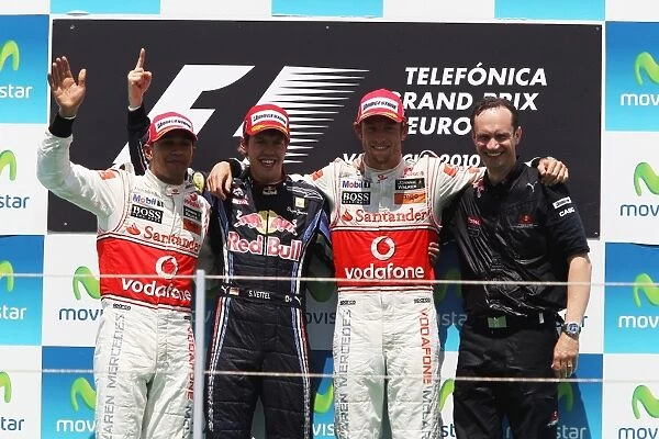 Formula One World Championship: The podium: Lewis Hamilton McLaren, second; Sebastian Vettel Red Bull Racing, race winner; Jenson Button McLaren