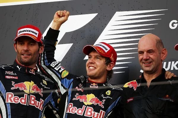 Formula One World Championship: Podium: Second placed Mark Webber Red Bull Racing, race winner Sebastian Vettel Red Bull Racing and Adrian Newey