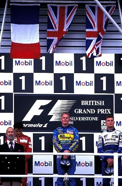 Formula One World Championship: The podium finishers Prince Michael of Kent, Jean Alesi Ferrari 2nd, Johnny Herbert Benetton 1st, David Coulthard
