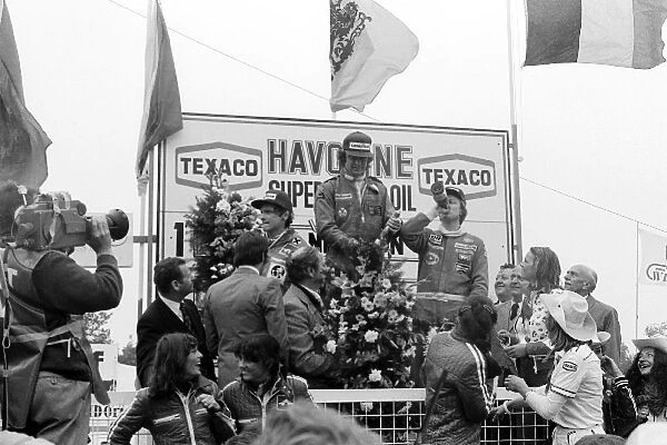 Formula One World Championship: The podium: Niki Lauda, Ferrari, second; Gunnar Nilsson, Lotus race winner; Ronnie Peterson, Tyrrell, third