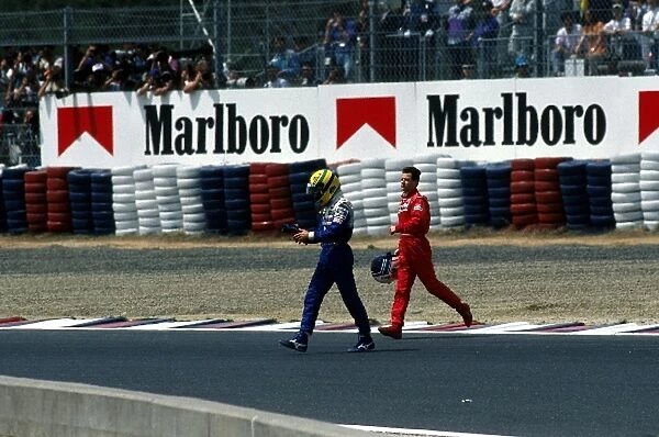 Formula One World Championship: Pole sitter Ayrton Senna Williams walks back to the pits with Nicola Larini Ferrari after colliding after at