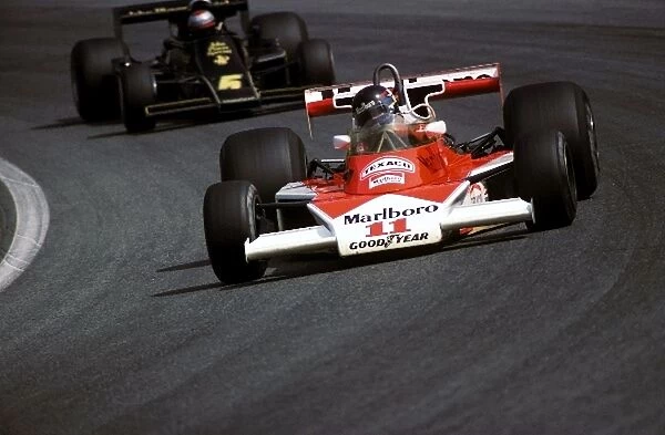 Formula One World Championship: Pole sitter James Hunt McLaren M23, who finished fourth, leads Mario Andretti Lotus 77, who finished just behind