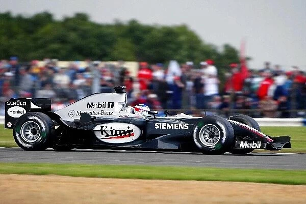 Formula One World Championship: Pole sitter Kimi Raikkonen McLaren Mercedes MP4  /  19B
