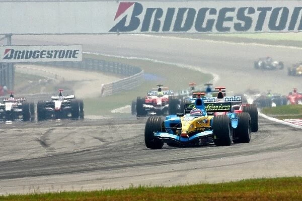 Formula One World Championship: Pole sitter and race winner Fernando Alonso Renault R25 leads at the start of the race