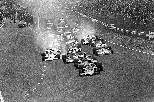 Formula One World Championship: Pole sitter Ronnie Peterson Lotus 72E leads the field into Tarzan at the start of the race
