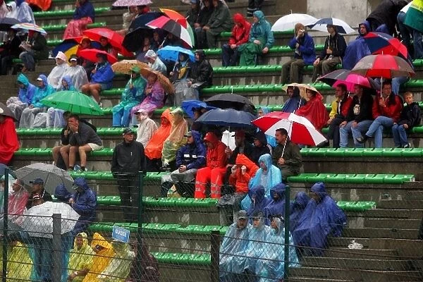 Formula One World Championship: The pouring rain and a lengthy delay for barrier repairs is testing the hardiest of race fans