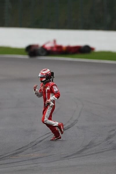 Formula One World Championship: Race retiree Kimi Raikkonen Ferrari crosses the track