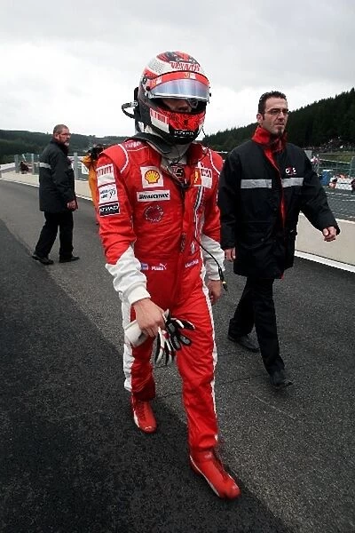 Formula One World Championship: Race retiree Kimi Raikkonen Ferrari walks back to the pits