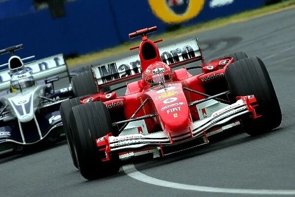 Formula One World Championship: Race retiree Michael Schumacher Ferrari F2004M leads Nick Heidfeld Williams BMW FW27