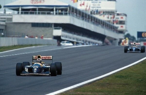 Formula One World Championship: Race winner Alain Prost Williams FW15C leads team mate Damon Hill Williams FW15C who retired with a blown engine