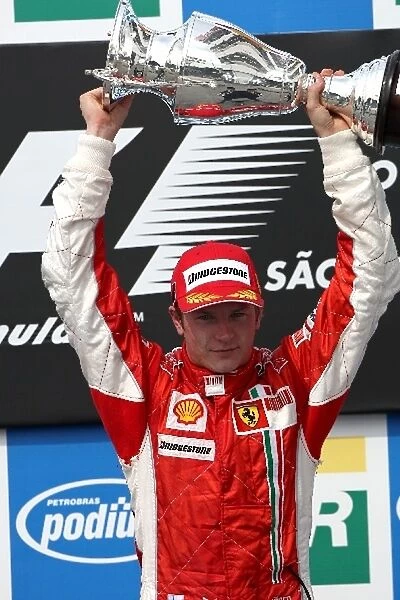 Formula One World Championship: Race winner and Champion Kimi Raikkonen Ferrari celebrates on the podium