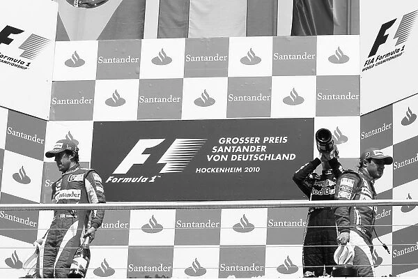 Formula One World Championship: Race winner Fernando Alonso Ferrari leaves the podium from the opposite side of second placed team mate Felipe
