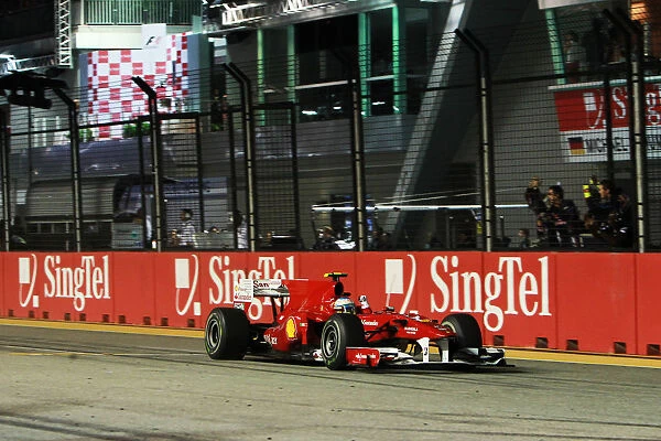 Formula One World Championship: Race winner Fernando Alonso Ferrari F10 takes the chequered flag